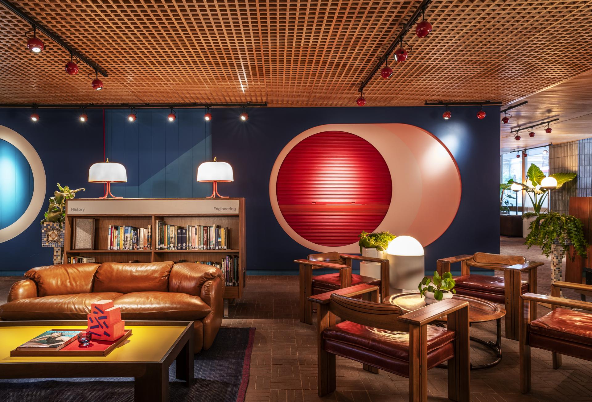 Stylish interior of The Standard, London, featuring modern furniture, decorative lighting, and vibrant wall art.