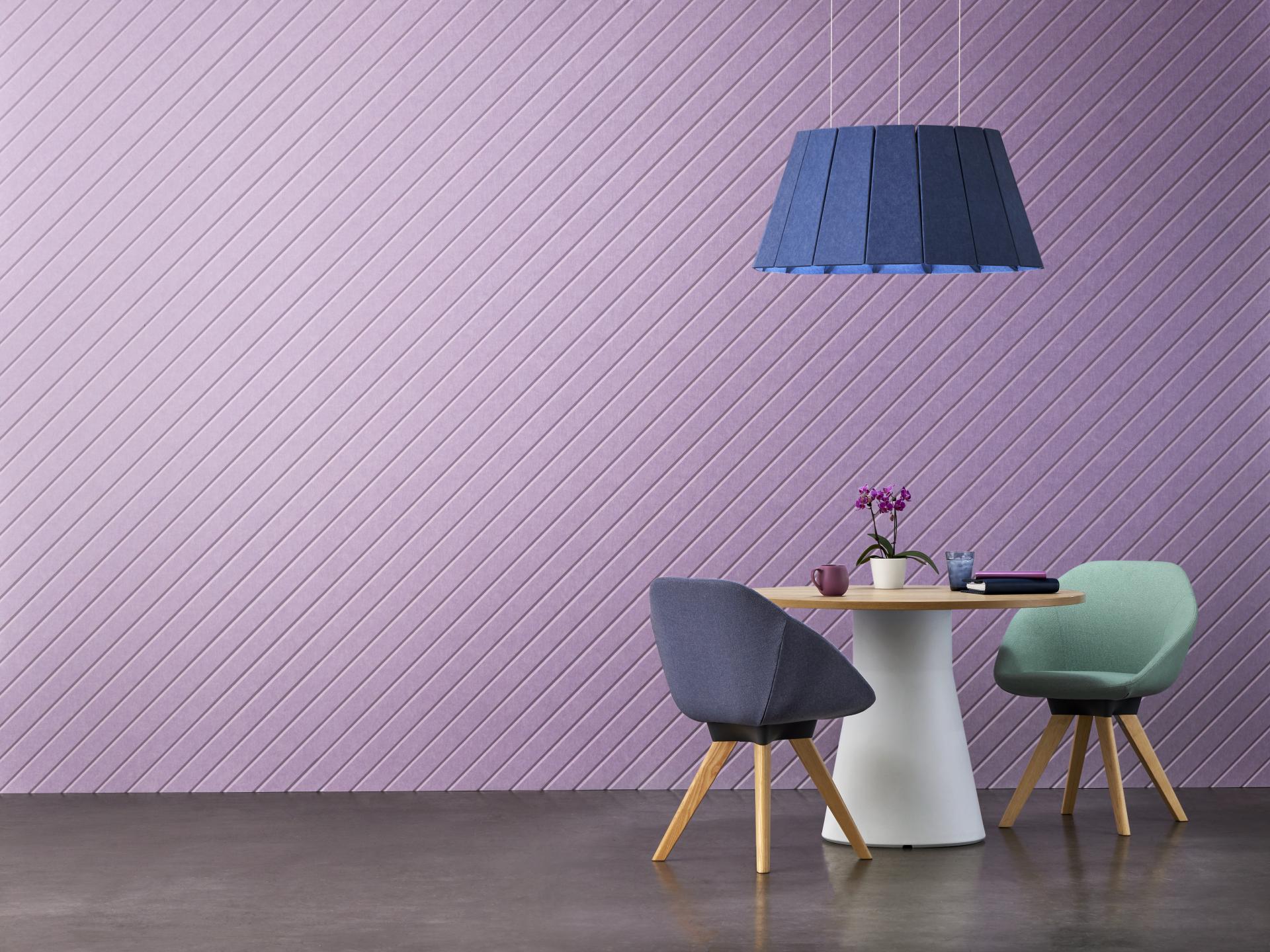 Modern dining area featuring new EchoPanel® colors, showcasing acoustic wall treatment and stylish furnishings with a pastel theme.