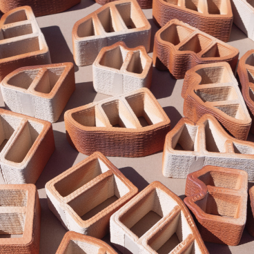 Variety of intricately designed 3D printed construction blocks showcasing innovative shapes and textures in a flat layout.