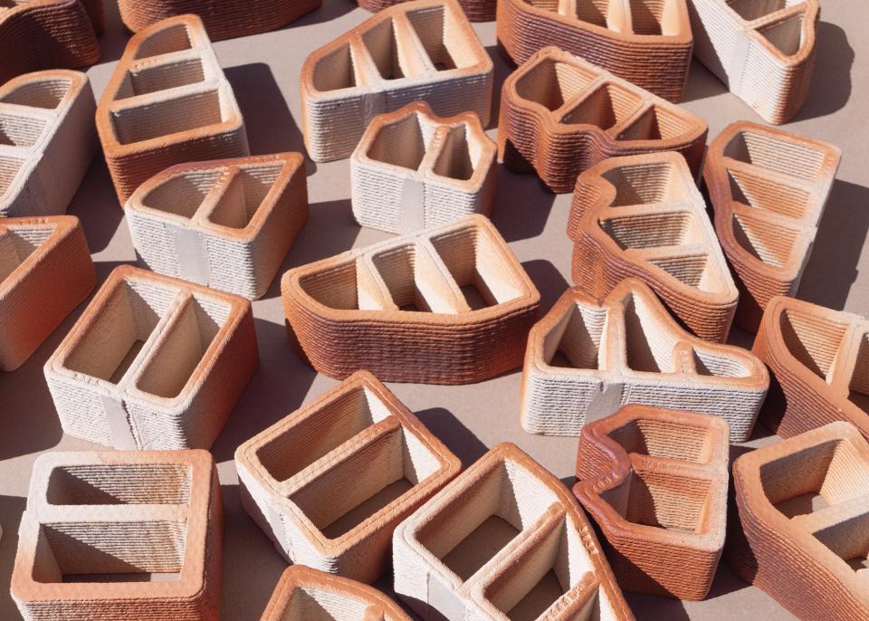 Variety of intricately designed 3D printed construction blocks showcasing innovative shapes and textures in a flat layout.