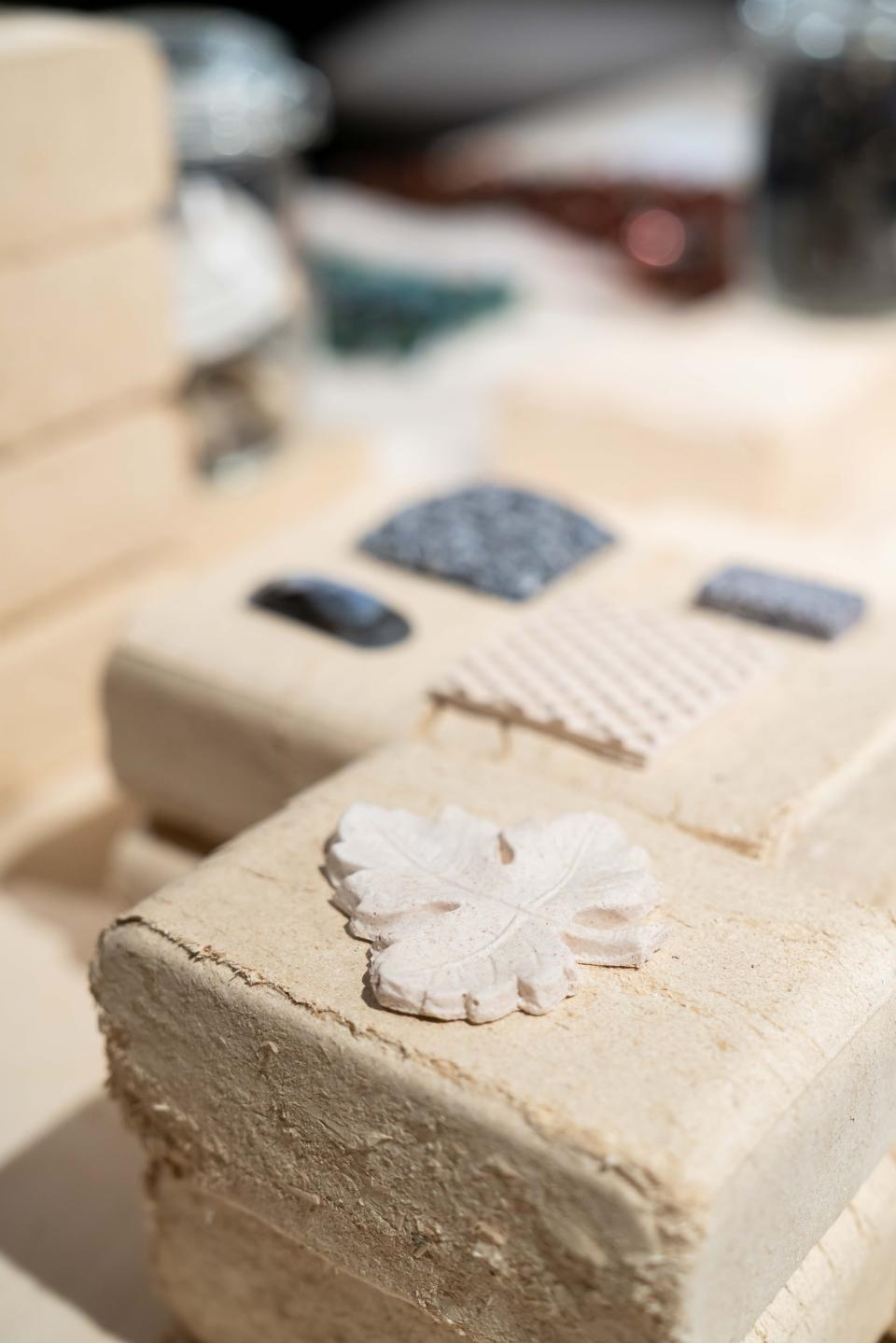 Biomaterial samples displayed at the "From The Ground Up" exhibition, showcasing innovative textures and sustainable design.