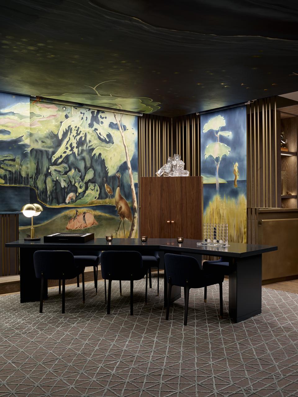 The luxurious reception area of a theatrical Leicester Square hotel featuring striking murals and modern furnishings.