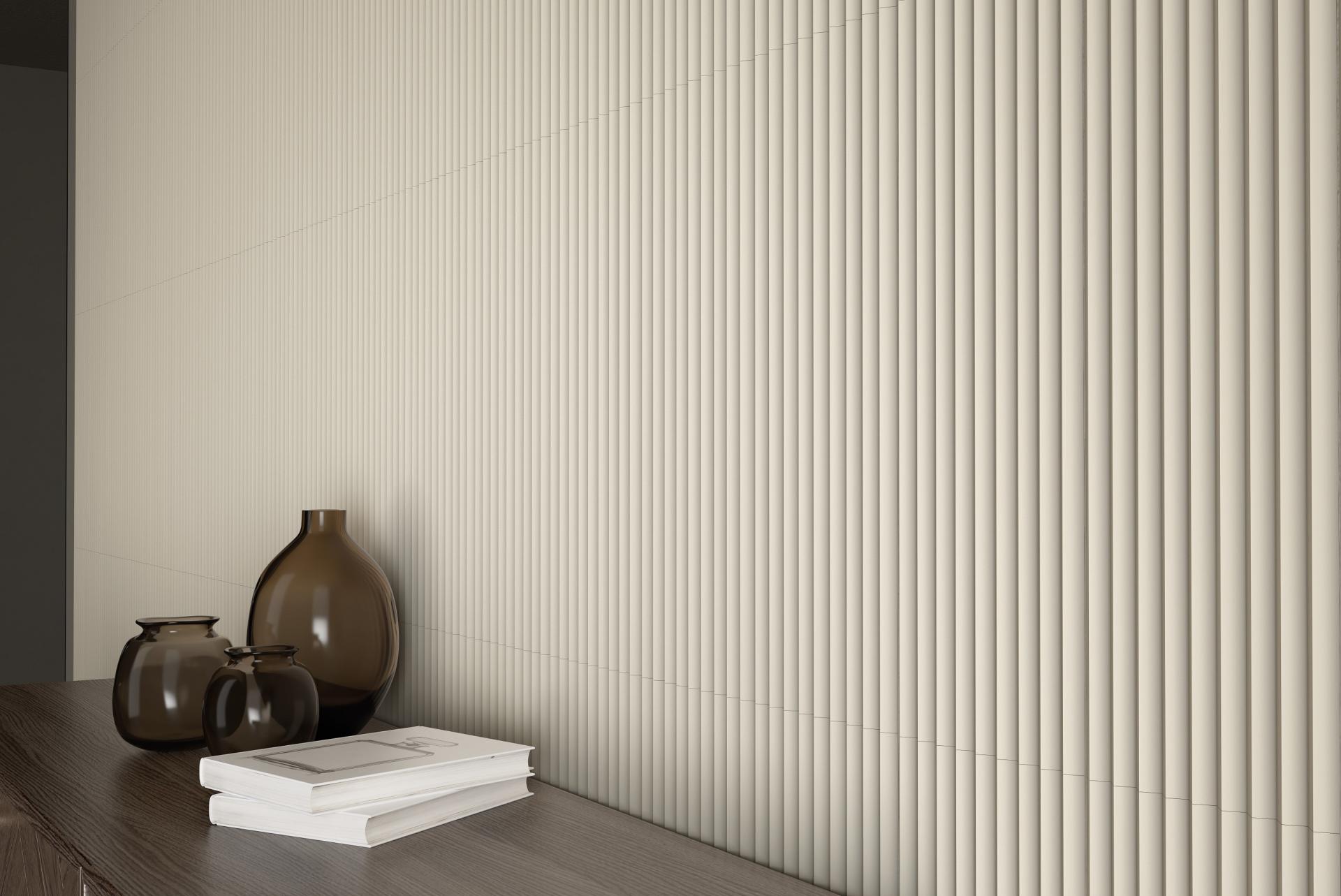 Textured beige tiles create a modern backdrop with decorative glass vases and stacked books on a wooden surface.