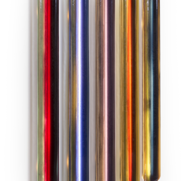 Colorful glass tubes displayed on a wall, showcasing unique designs from independent designers at the London Design Fair.