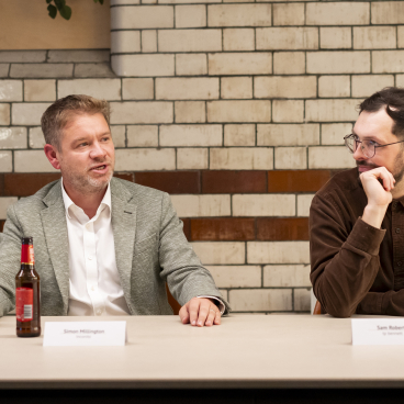 Two panelists engage in discussion at a roundtable about the impact of data on the workplace.