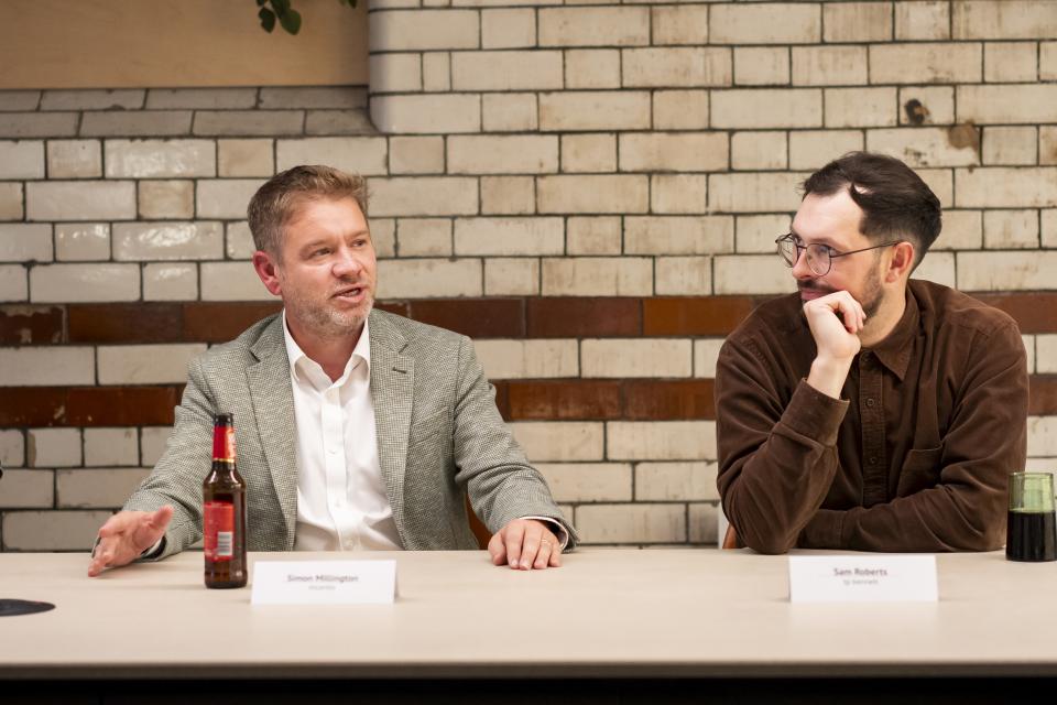 Two panelists engage in discussion at a roundtable about the impact of data on the workplace.