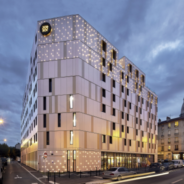 JO&JOE Paris Gentilly exterior showcasing modern architecture and starry lighting, recognized as Best Hotel & Tourism Resort 2020.