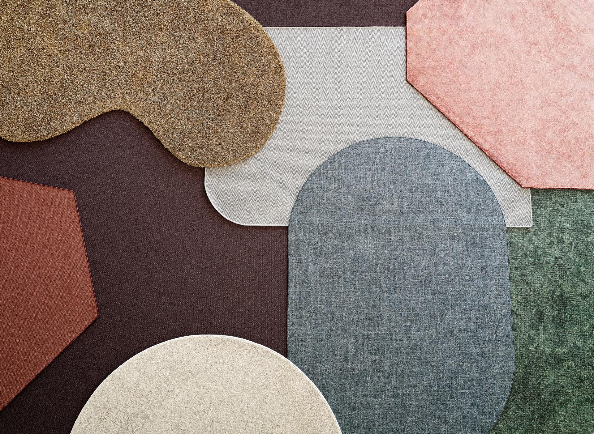 Colorful, textured floor coverings displayed at Orgatec 2024, highlighting sustainable materials and innovative design for modern workplaces.