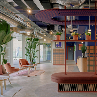 Modern interior of Enso student accommodation in Colchester, featuring vibrant decor, plants, and comfortable seating areas.