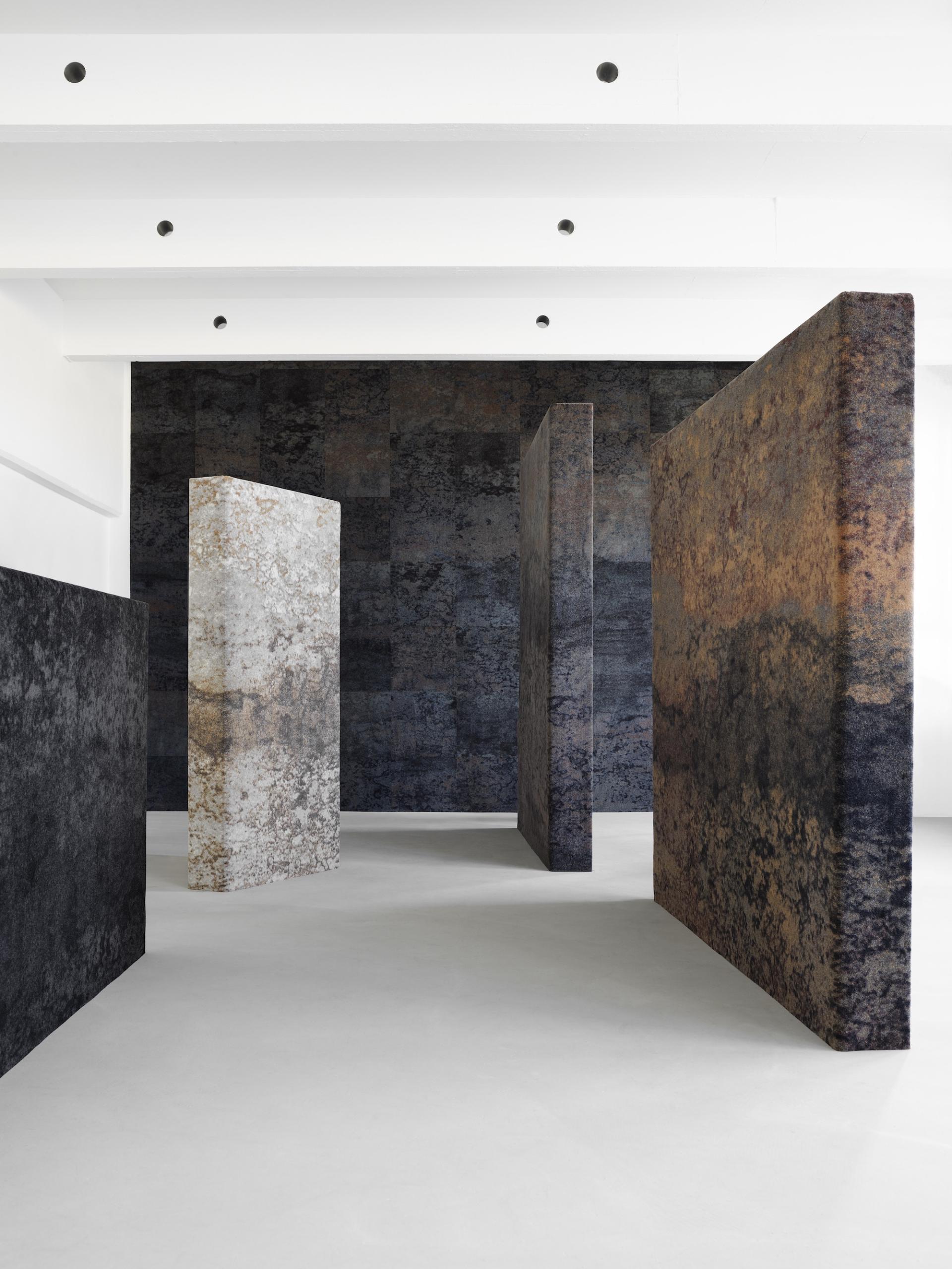 Industrial Landscape collection featuring textured EGE carpets by Tom Dixon in a modern gallery setting.
