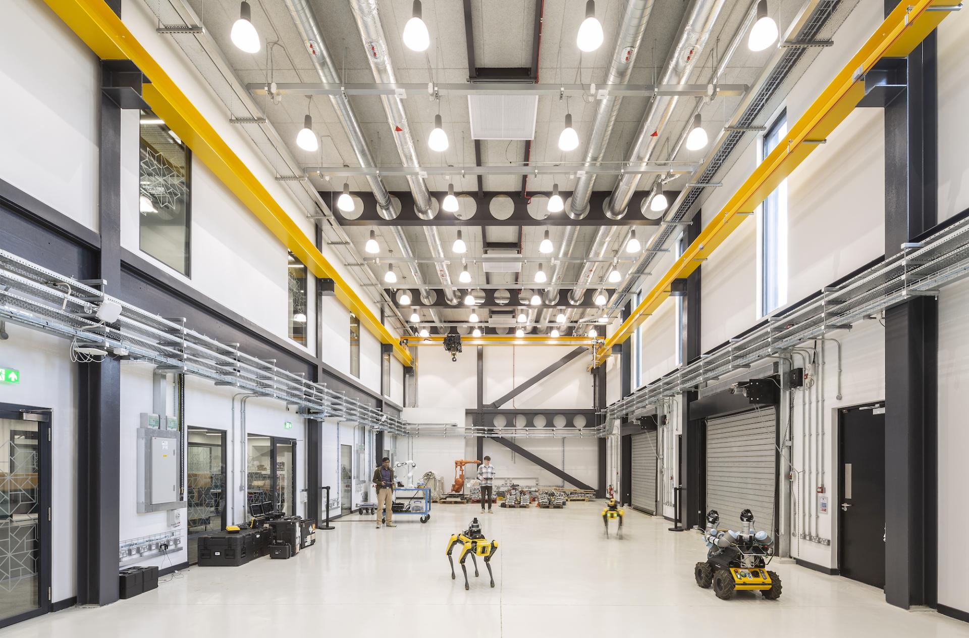 Contemporary workspace featuring robotics, large industrial space, and innovative design elements in architecture.