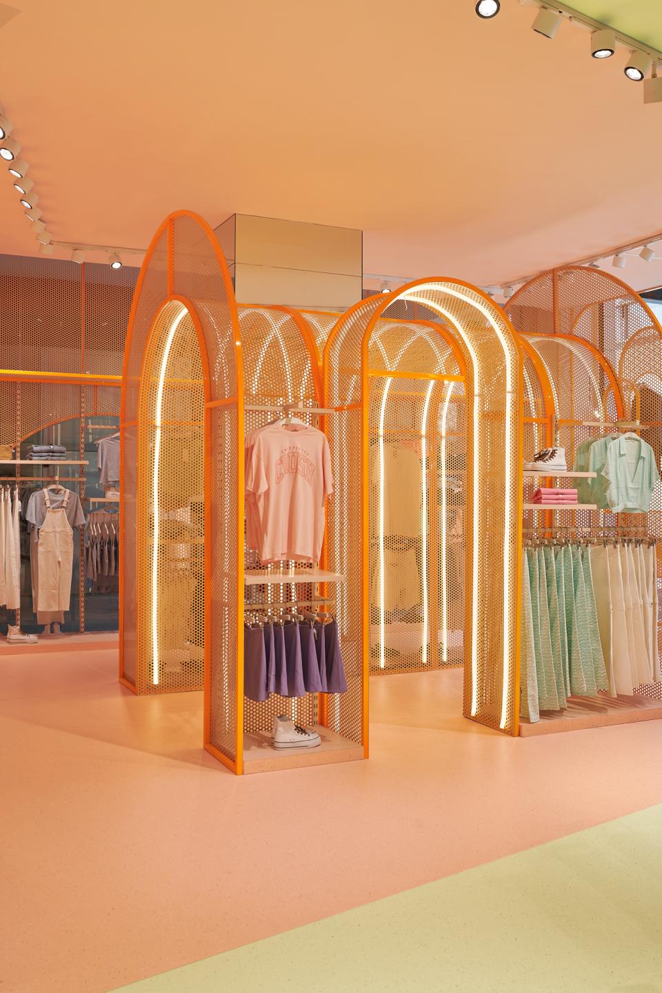 Vibrant Mango Teen store interior featuring citrus-themed design elements, colorful display racks, and stylish clothing arrangements.