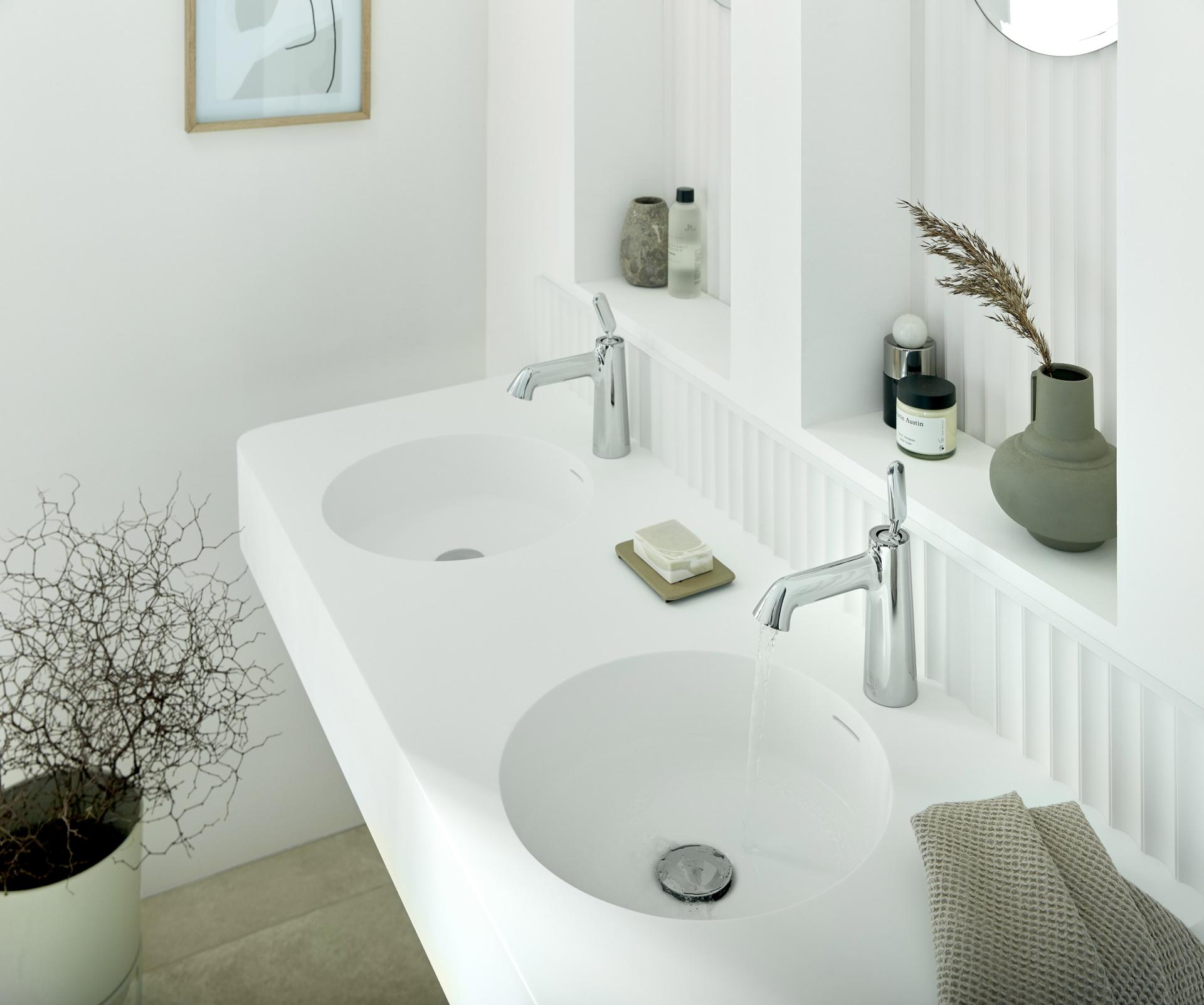 Modern bathroom featuring sleek Arrondi sinks by VADO, designed in collaboration with Conran and Partners, with aesthetic decor elements.