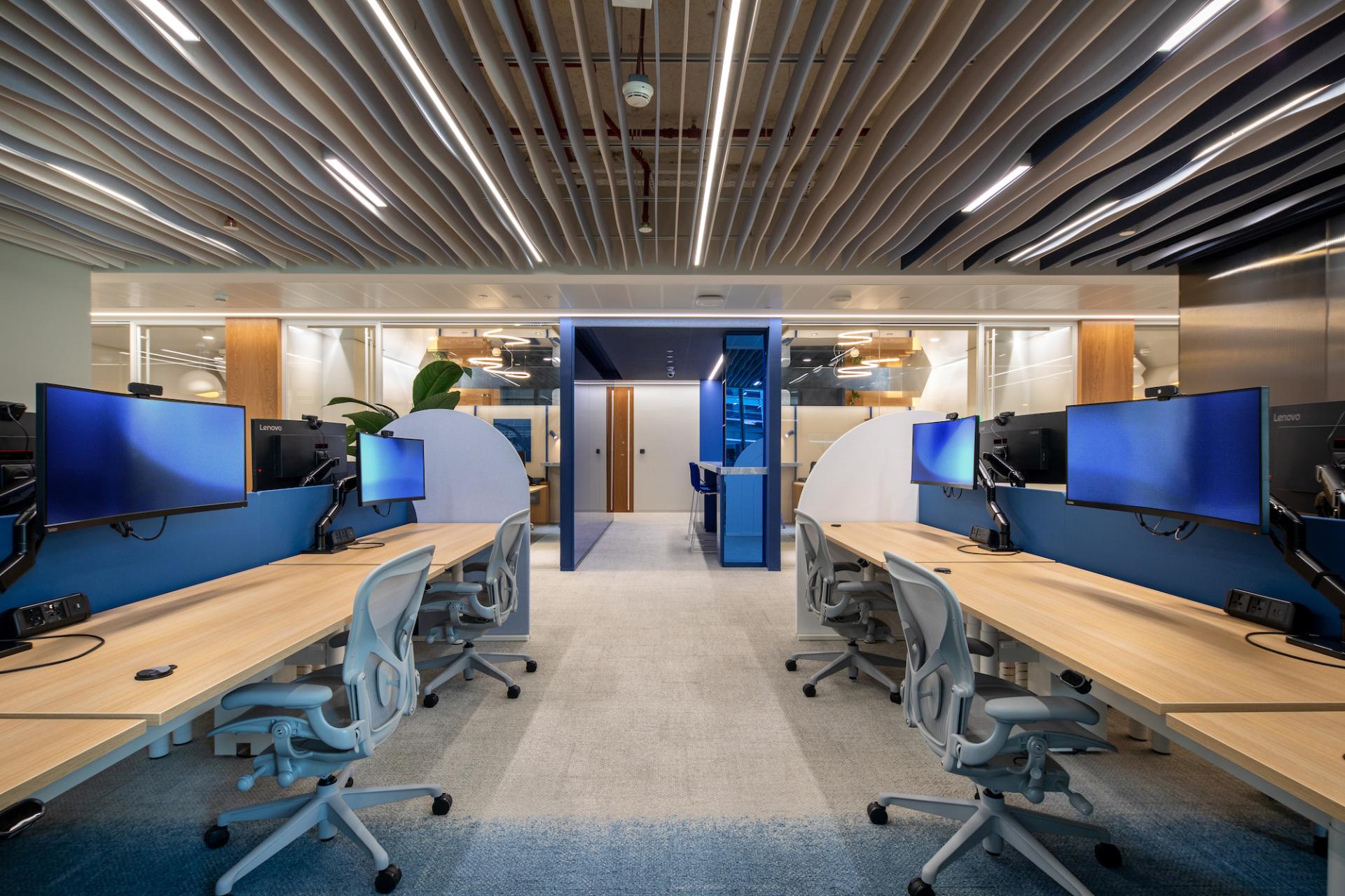 Modern office workspace in Dubai featuring colorful decor, ergonomic furniture, and collaborative areas inspired by nature.