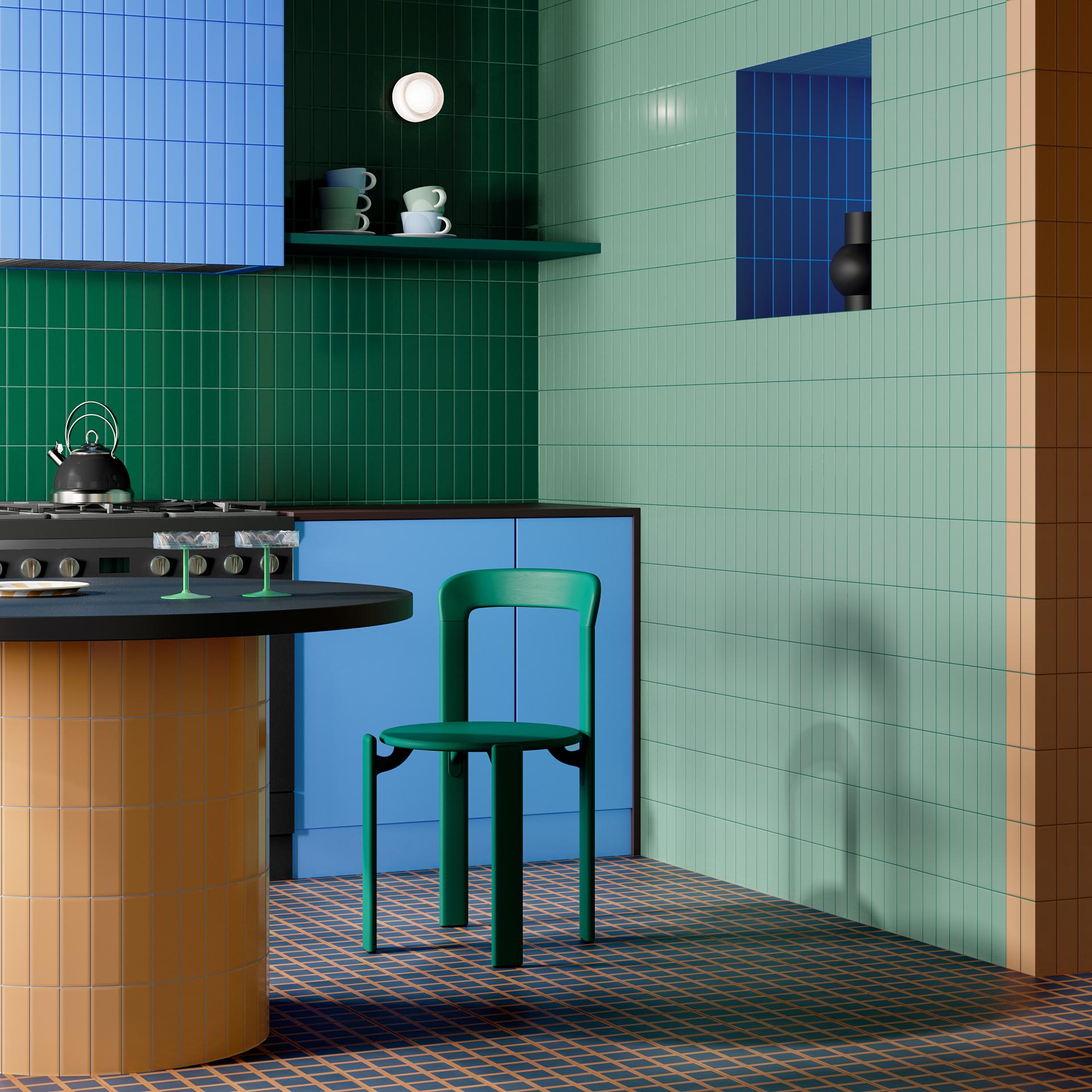 Colorful kitchen interior featuring playful tile combinations, a round table, and a green chair from the Färgblock collection.