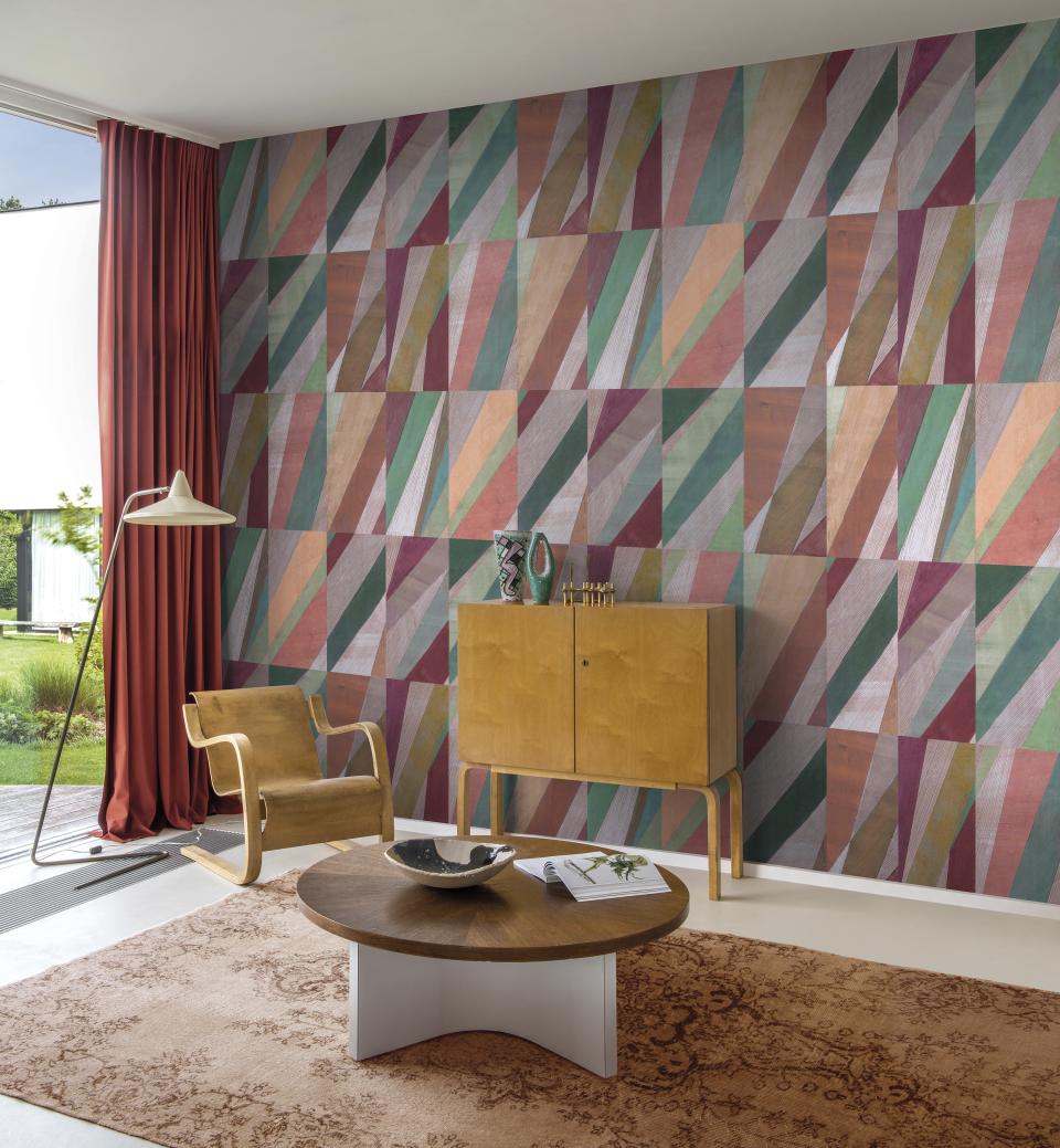 Stylish living room featuring Omexo's colorful wallcovering design with geometric patterns, complemented by modern furniture elements.