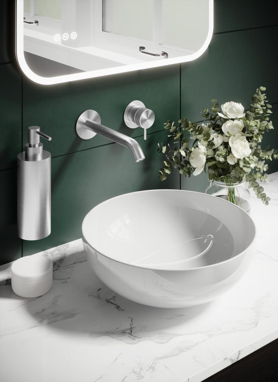 Contemporary bathroom setup featuring a sleek bowl sink, brassware faucet, and stylish floral arrangement on a marble countertop.