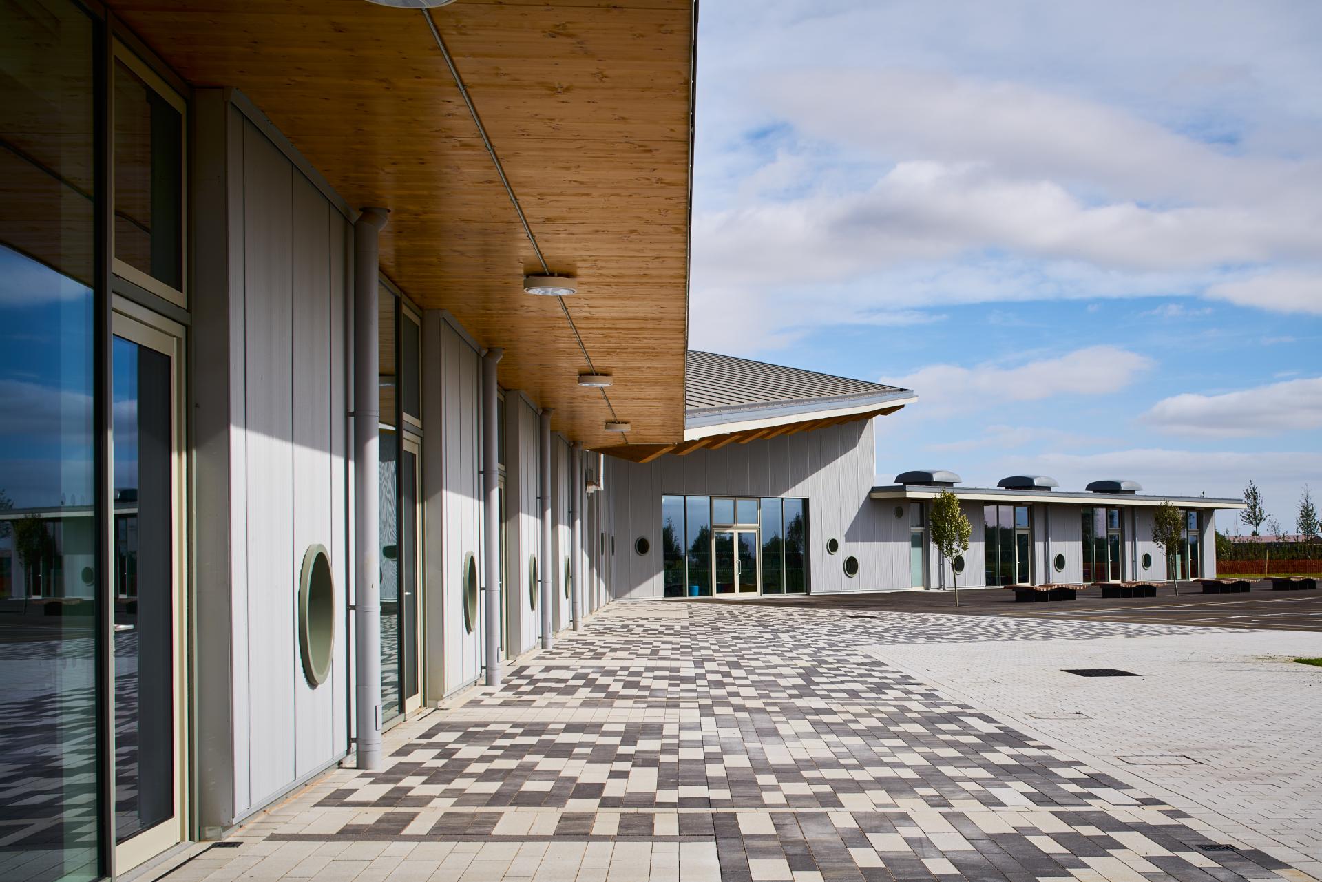 Modern architectural design showcasing Cross Laminated Timber structures with a contemporary plaza and landscaping elements.
