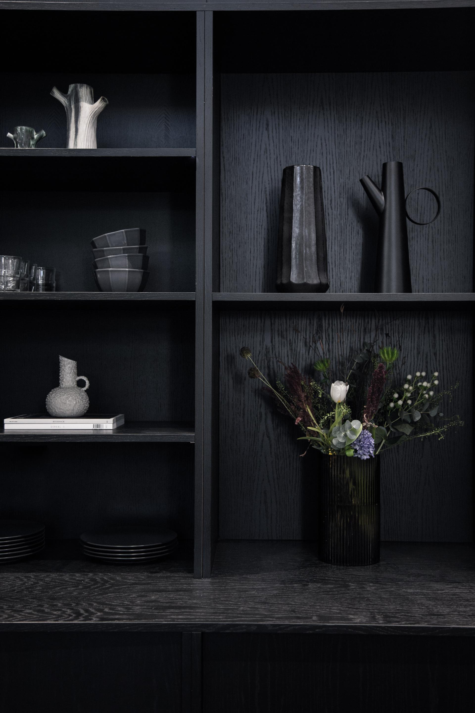 Minimalistic indoor display featuring sculptural vases and a floral arrangement, reflecting Youth Studio's modern design aesthetic.