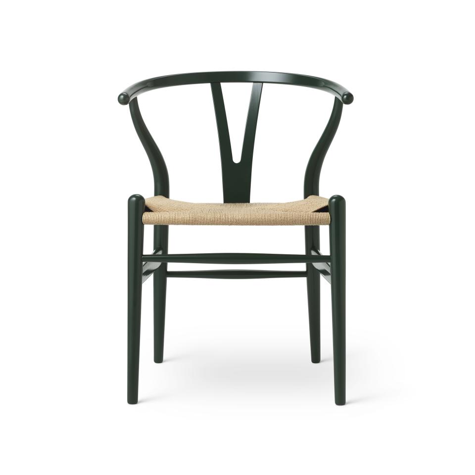 Wishbone chair by Carl Hansen & Son in a deep green finish, featuring a natural woven seat, showcasing Danish design elegance.