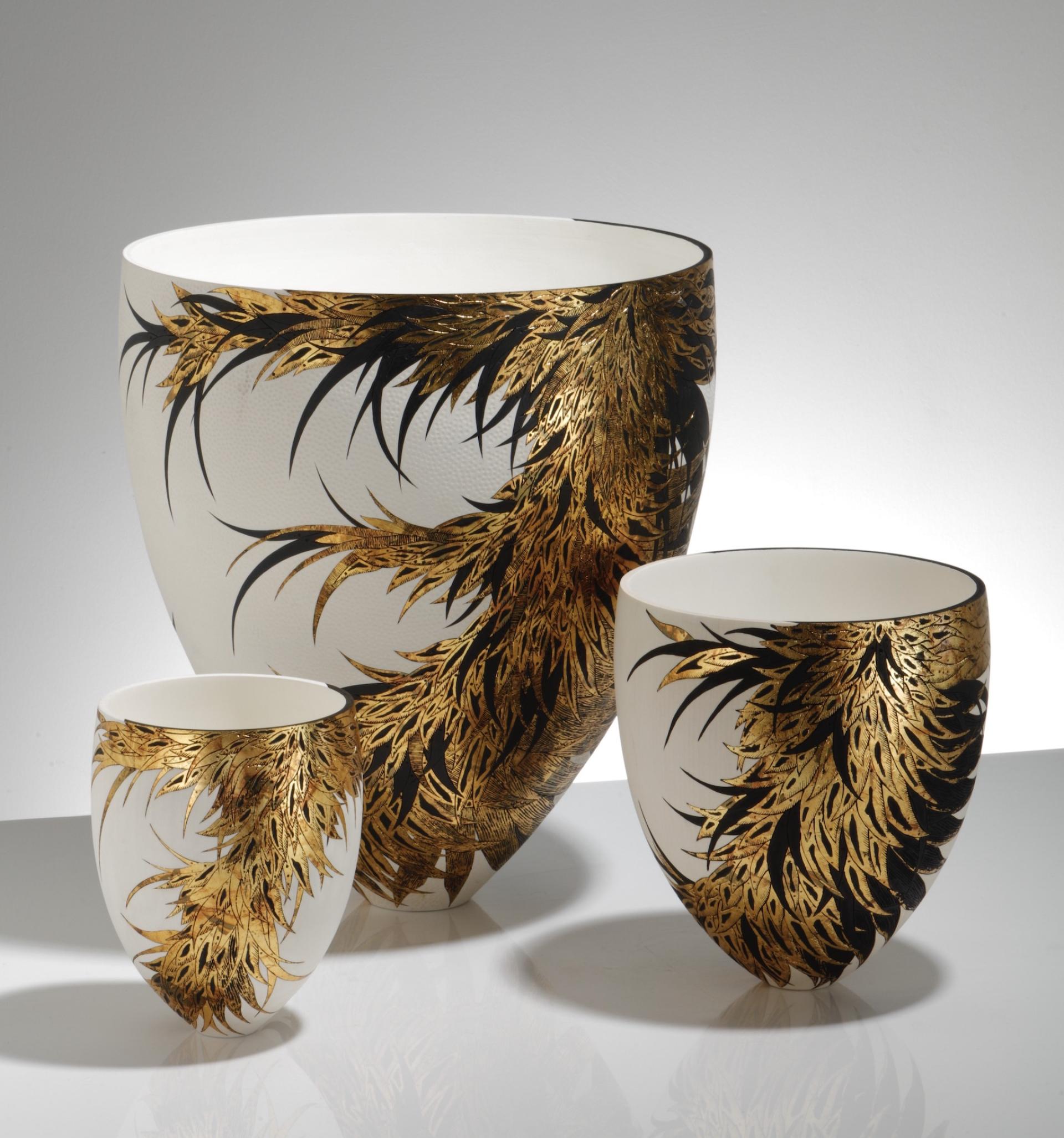 Elegant ceramic vases with intricate black and gold leaf designs, showcasing creative craftsmanship from the North West of England.