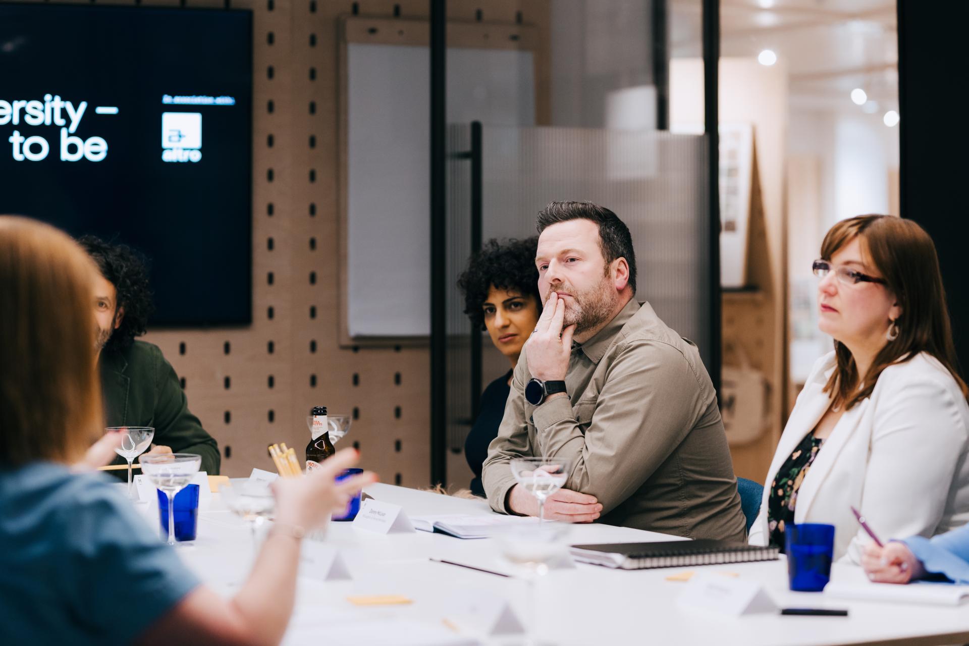 Participants engaged in a roundtable discussion on neurodiversity at Material Source Studio, emphasizing the importance of flexibility.