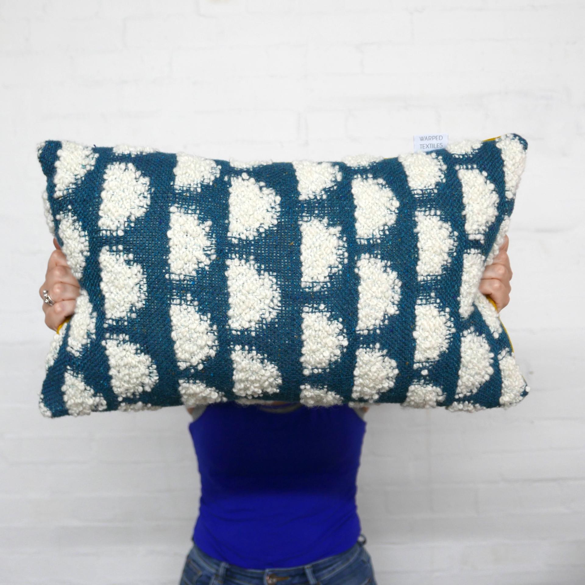 Colorful handmade cushion featuring a unique blue and white pattern, showcasing Glasgow's vibrant creative craft scene.