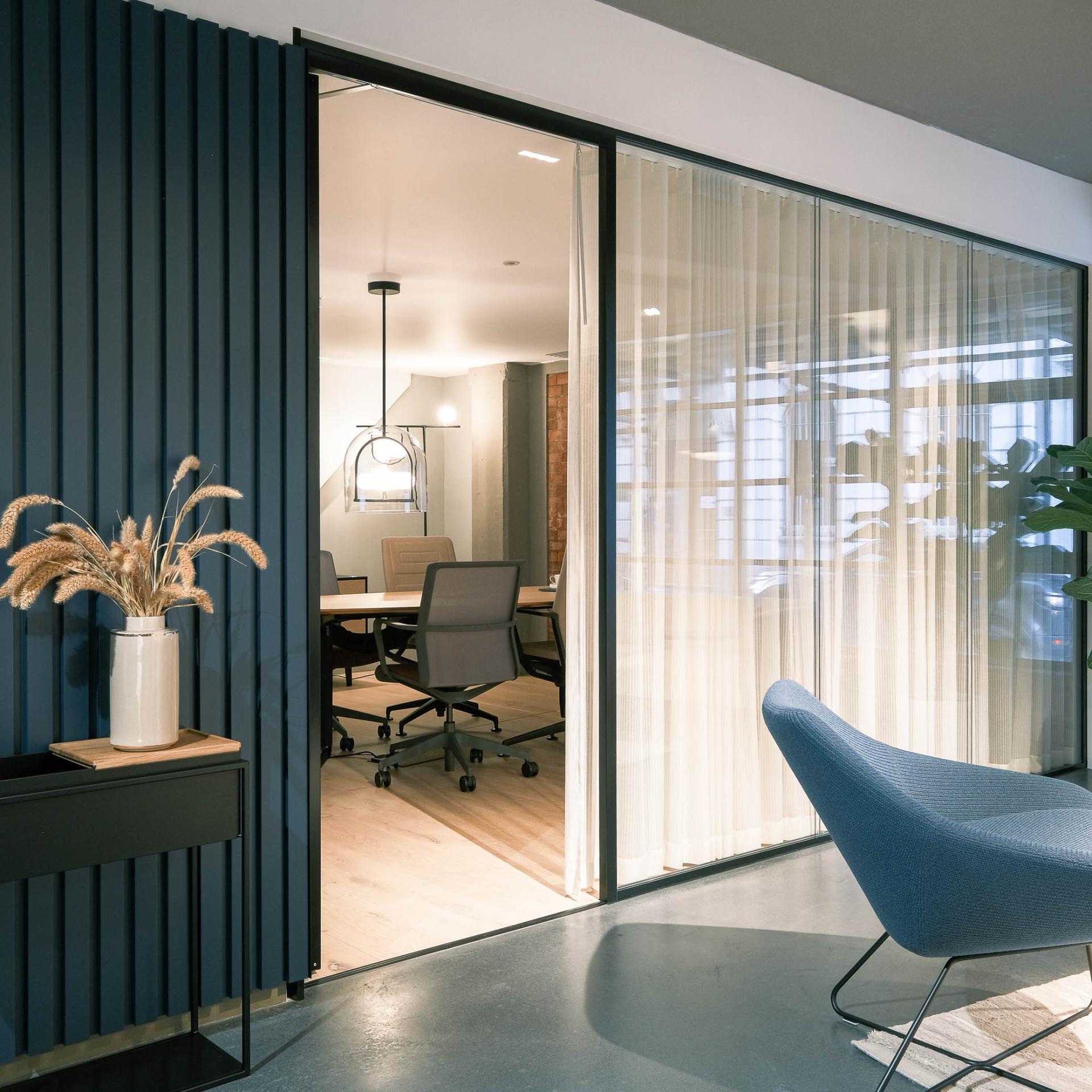 Stylish interior of Ekho Studio featuring a modern workspace, leafy plants, and artistic design elements for accessible art.