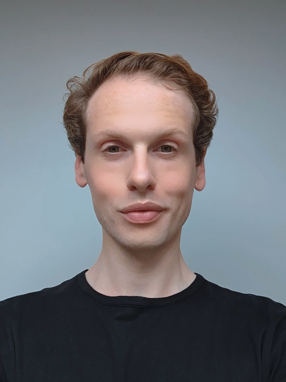 William Lee, lead designer at Giles Miller Studio, poses with a thoughtful expression against a neutral background.