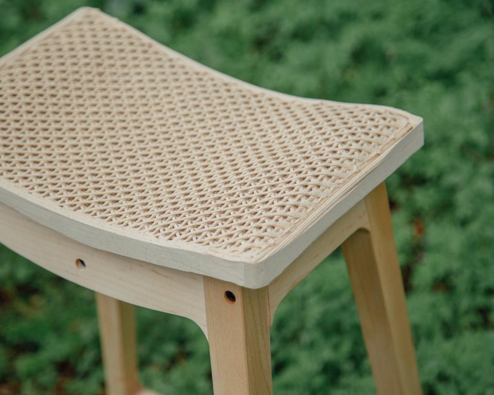 WoodenWood Stool featuring a unique woven surface created from 3D-printed sawdust, designed for sustainability in furniture.