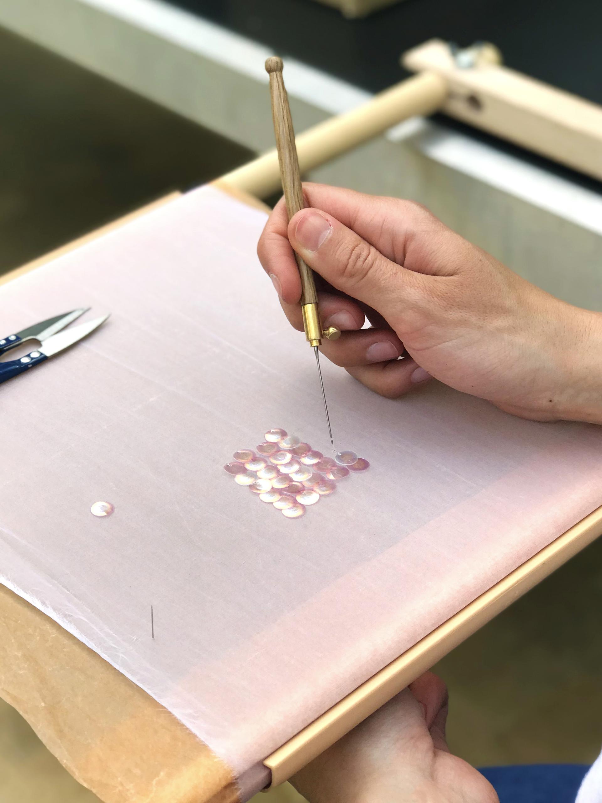 Crafting bio iridescent sequins from wood using a sewing tool, showcasing the eco-friendly material design process.