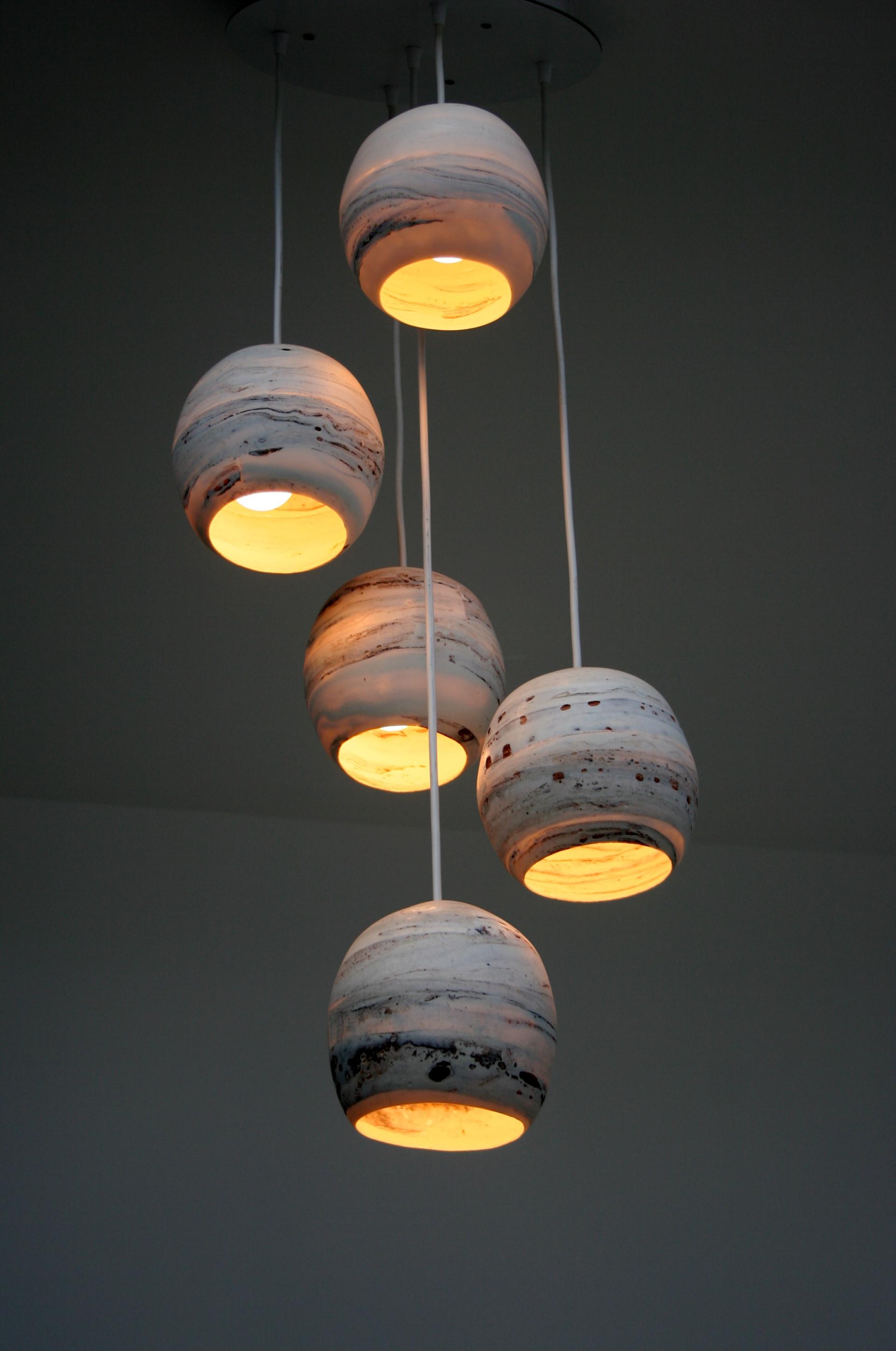 Chic pendant lights featuring a modern design with marble-like patterns, illuminating a stylish interior space.