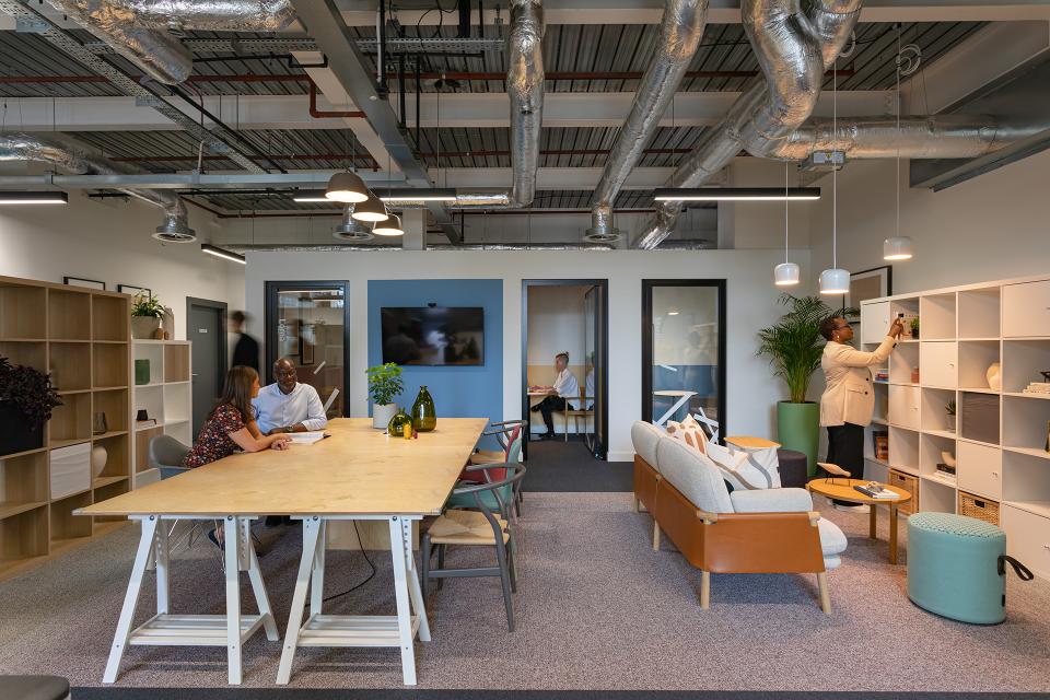 Modern workspace designed for community support, featuring collaborative areas and personal workstations for First Love Foundation.
