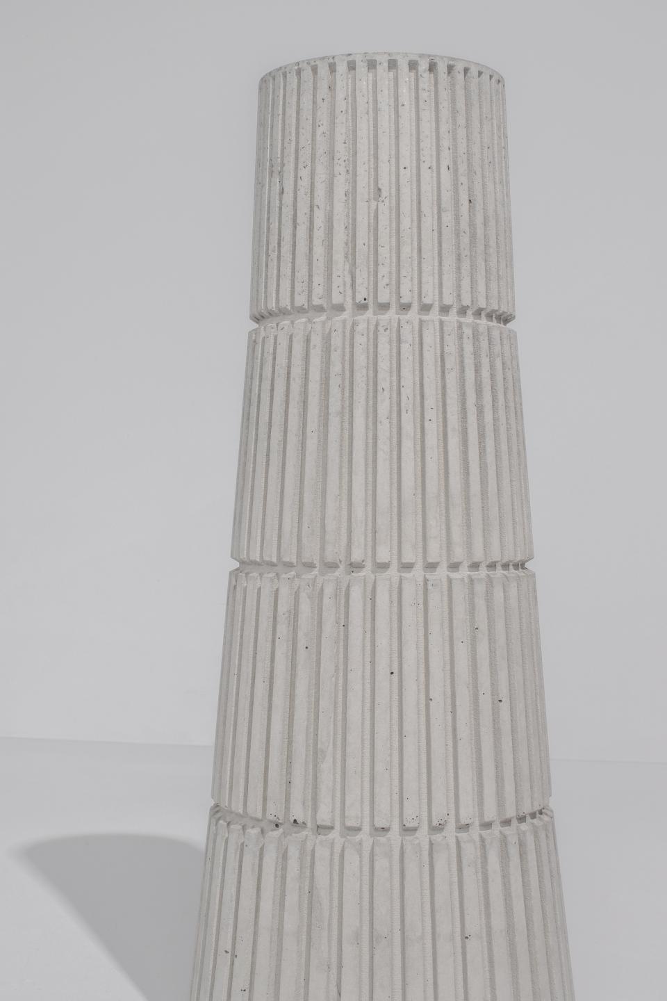 Stylish concrete planter from Tiipoi's Siment collection, showcasing modern architectural design with textured vertical lines.