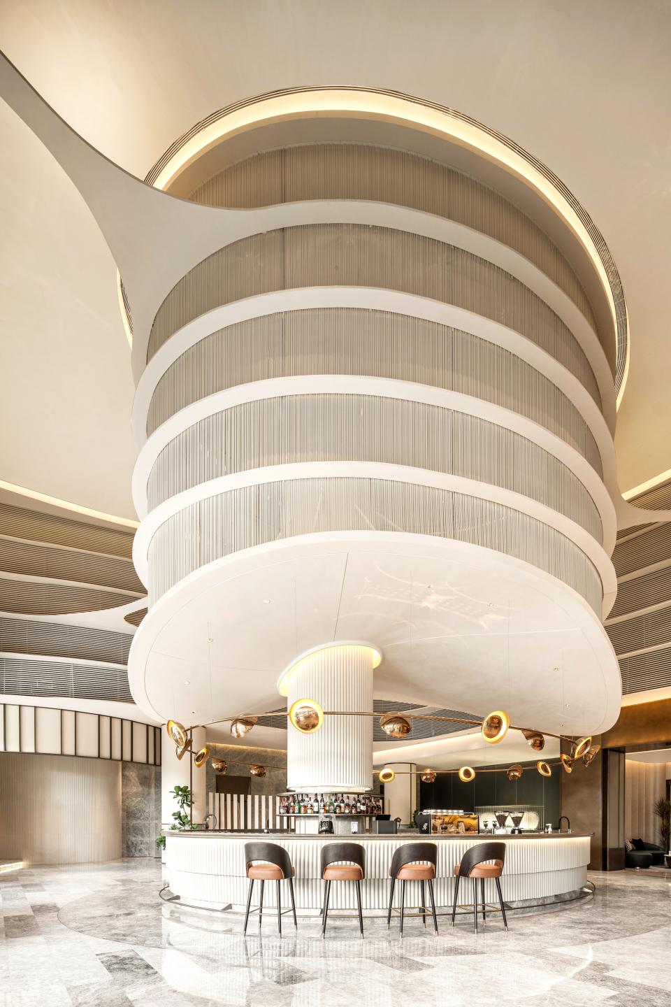 Sleek interior design of the Rhythm community centre, showcasing a modern bar with elegant lighting and seating.