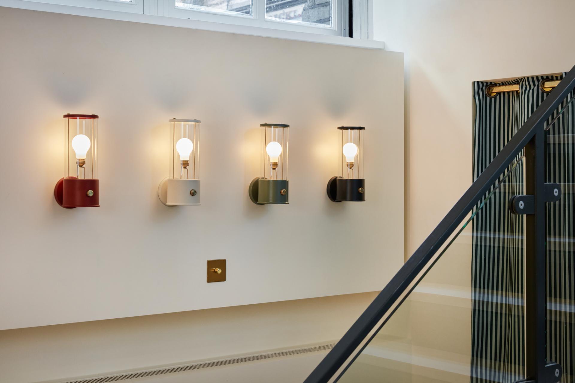 Stylish wall-mounted lamps illuminate a modern showroom, showcasing Tala's eco-friendly lighting design in Shoreditch.