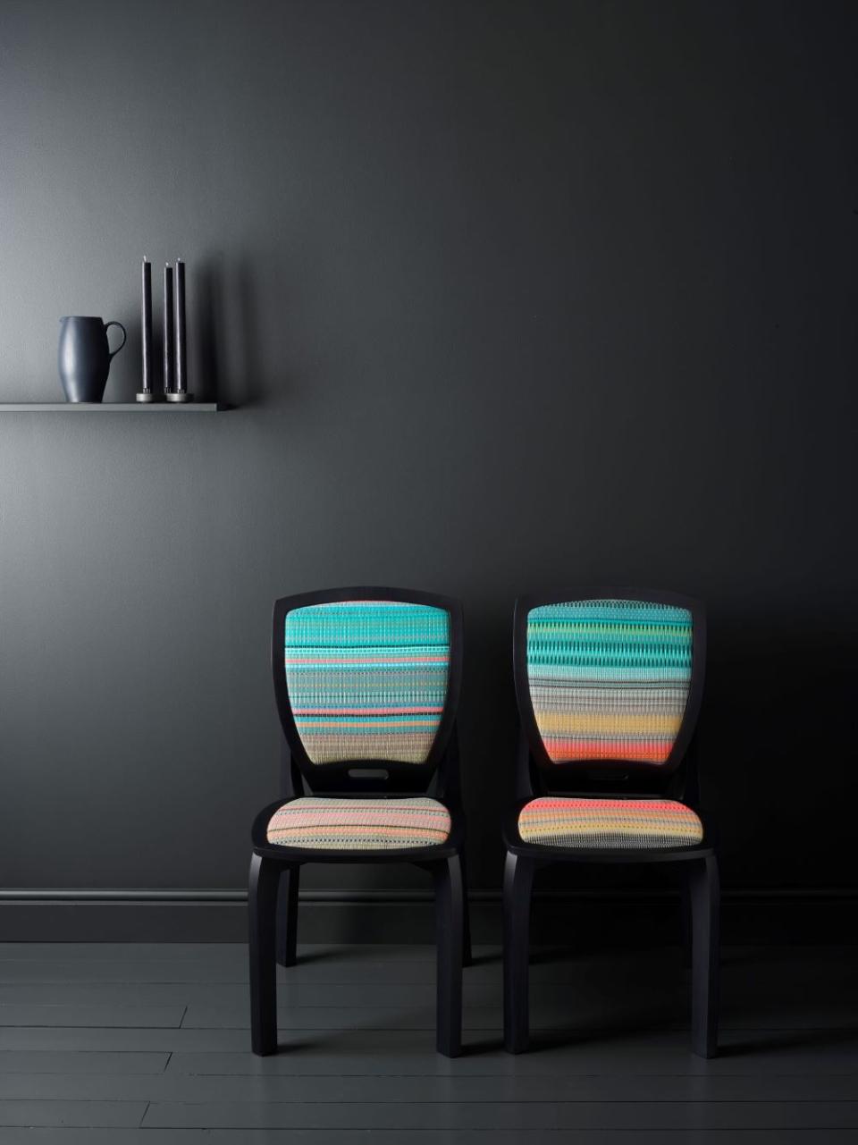 Scandinavian design chairs with vibrant woven patterns against a dark wall, highlighting contemporary aesthetics for Decorex International.