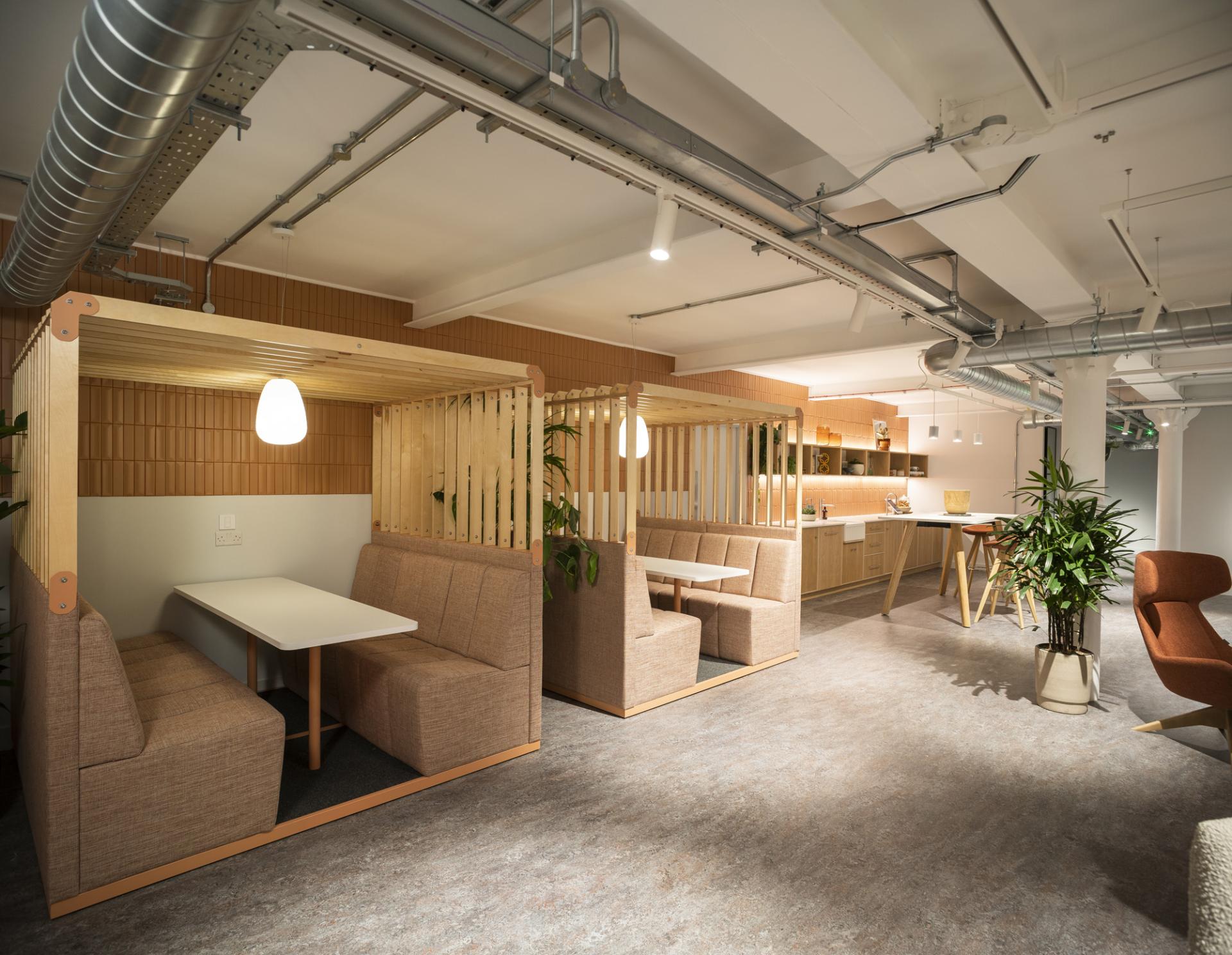 Contemporary workspace design at Material Source Studio in Manchester, featuring cozy booths and a welcoming atmosphere.