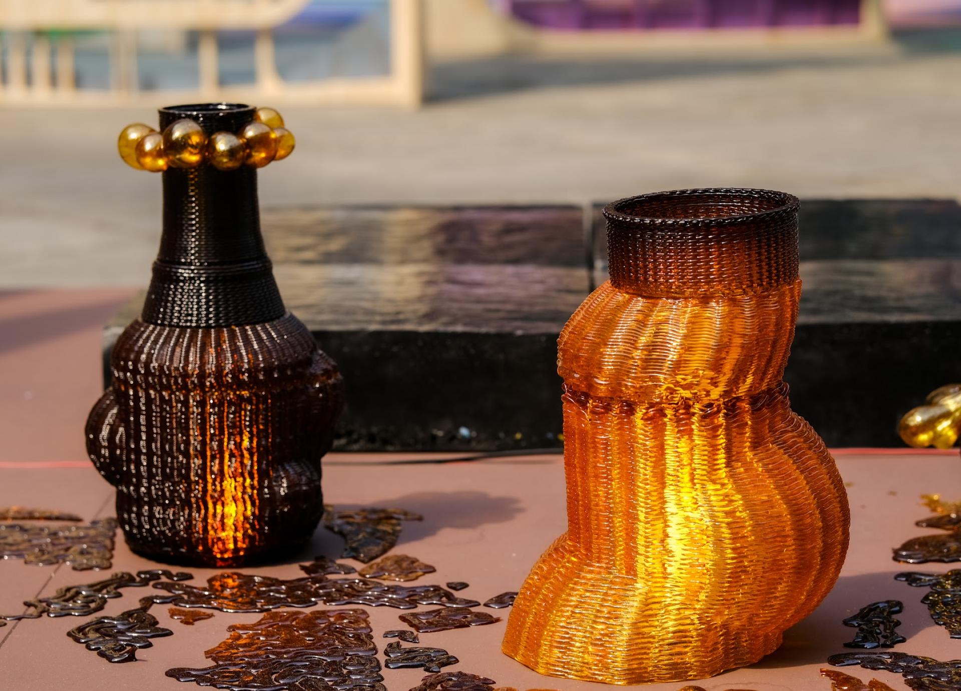 Unique 3D-printed decorative vases displayed outdoors, showcasing innovation in sustainable design and home decor for the construction industry.