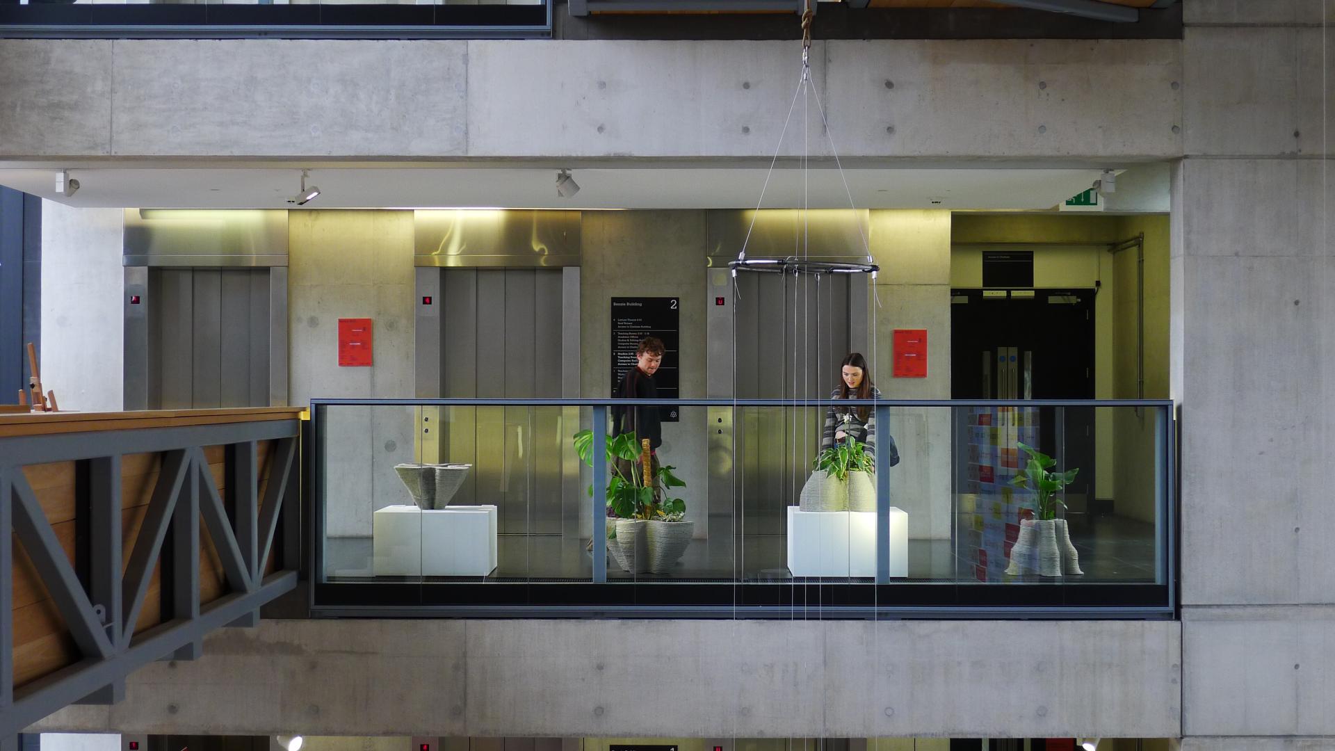 Visitors engage with innovative installations in the Manchester School of Art's modern interior space.