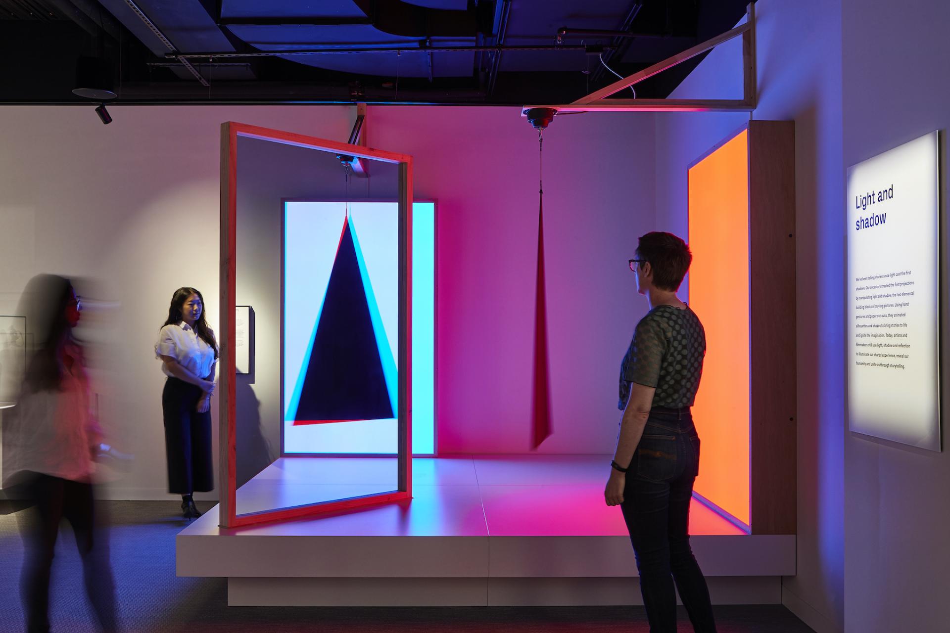 Interactive exhibit at ACMI showcasing vibrant light and shadow installations, engaging visitors in screen culture exploration.