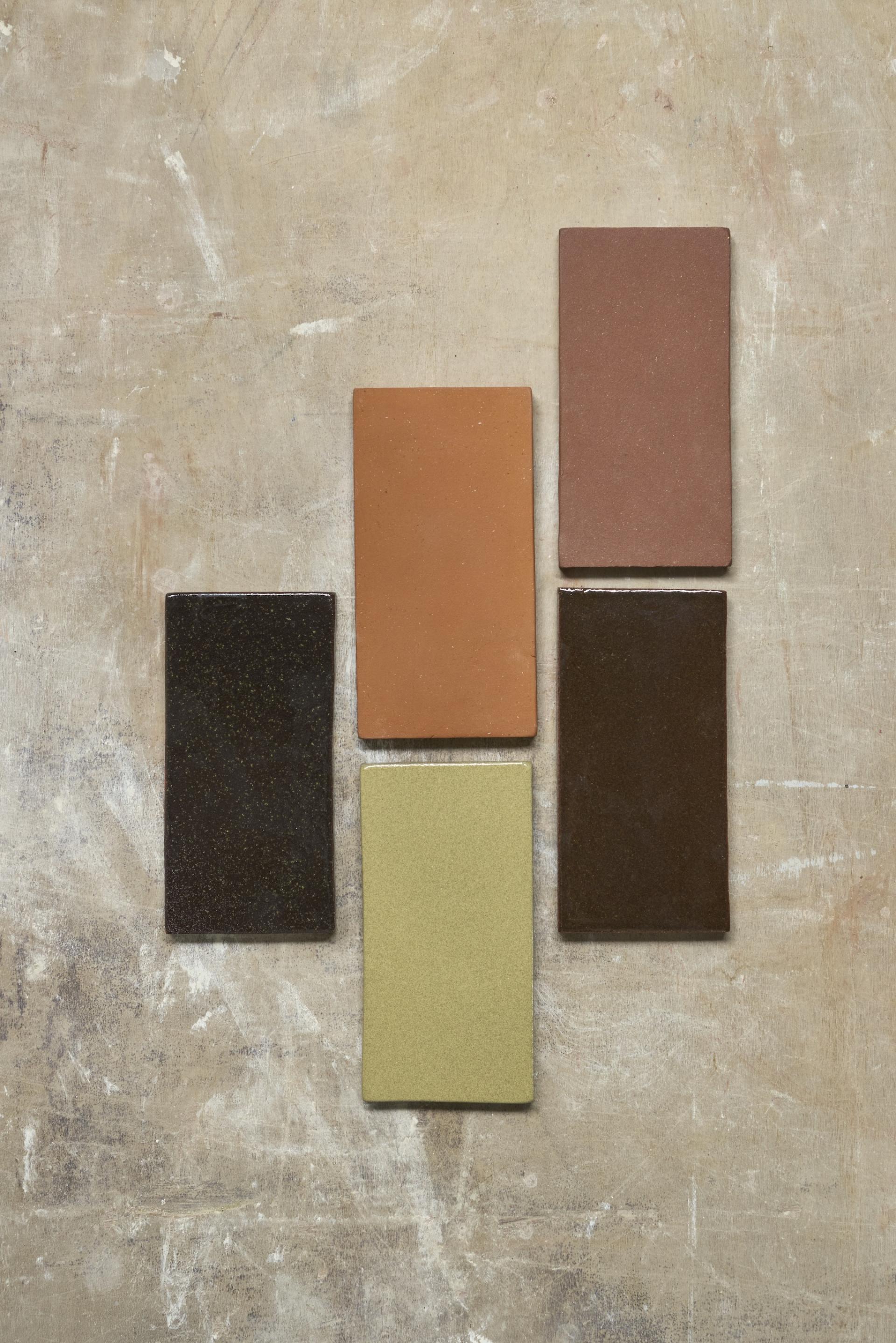 Tiles made from London’s waste, showcasing various colors and textures, part of Jeffrey Miller's transformative project.