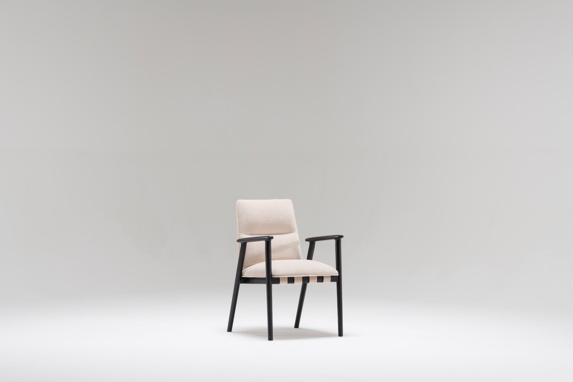 Modern chair design featuring a light fabric seat and dark wooden frame, showcasing innovative aesthetics and functionality.