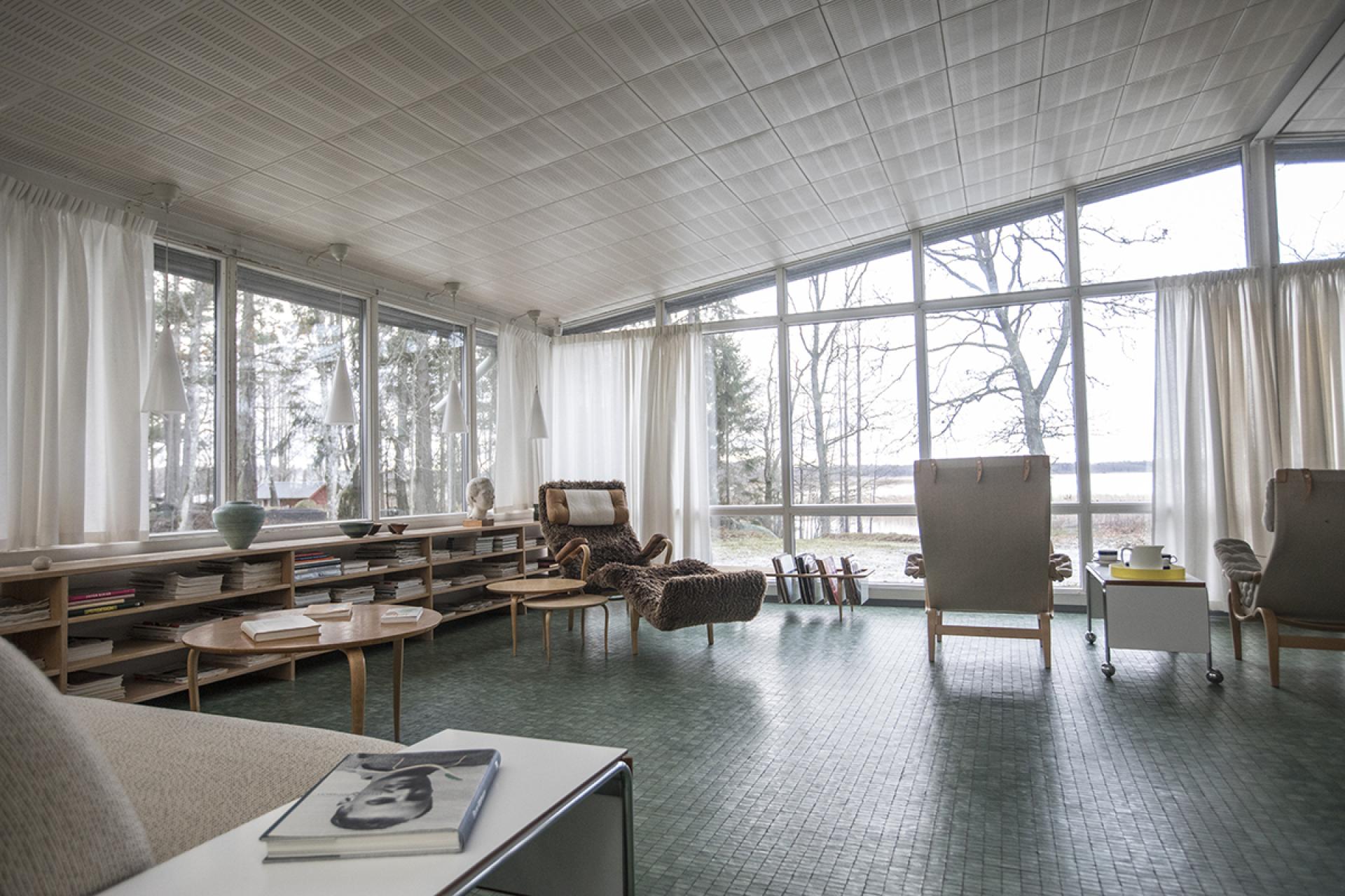 Bright, spacious living room in Södra Kull, showcasing modern Swedish design and large windows with a scenic view.