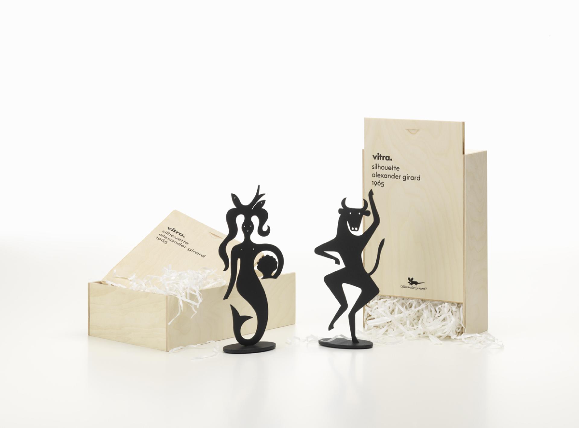 Black silhouette figures designed by Alexander Girard displayed in a wooden box, part of Vitra's Accessories Collection.