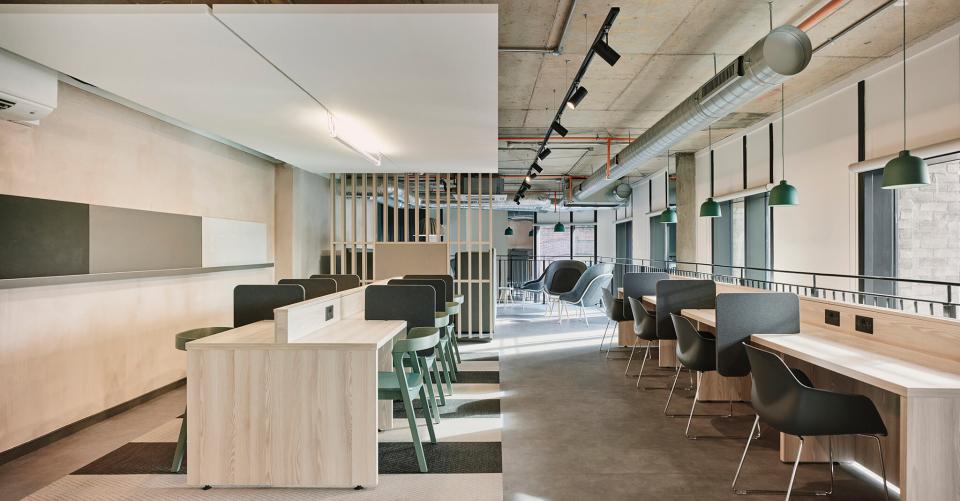 Modern study area in The Tannery student living space, featuring collaborative workstations and stylish seating in Leicester.