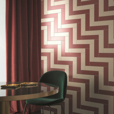 Colorful glazed porcelain tiles from the Pittorica collection by Studiopepe, enhancing a stylish interior space.