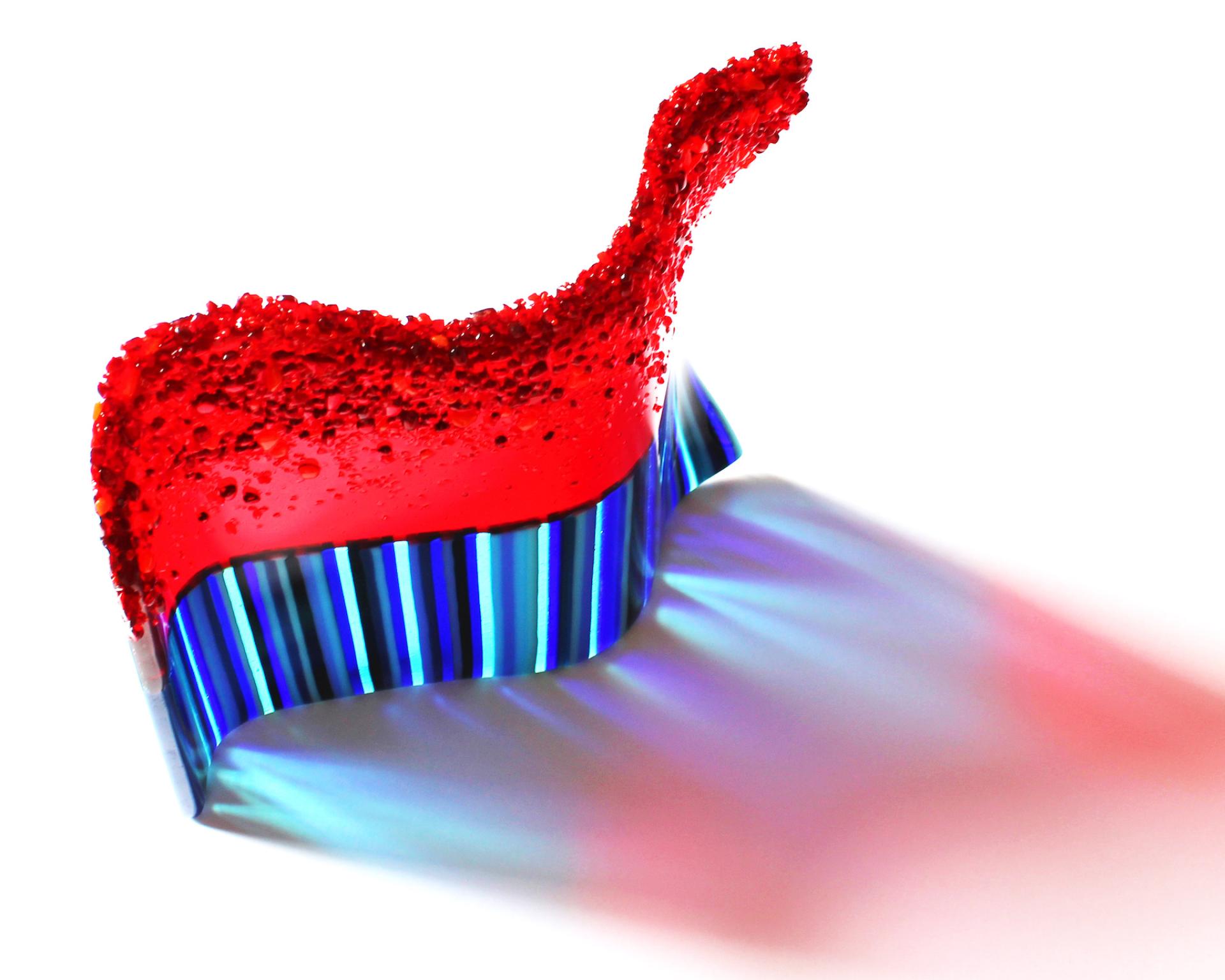 Vibrant red and blue craft sculpture highlighting innovative design from the creative community in North West England.