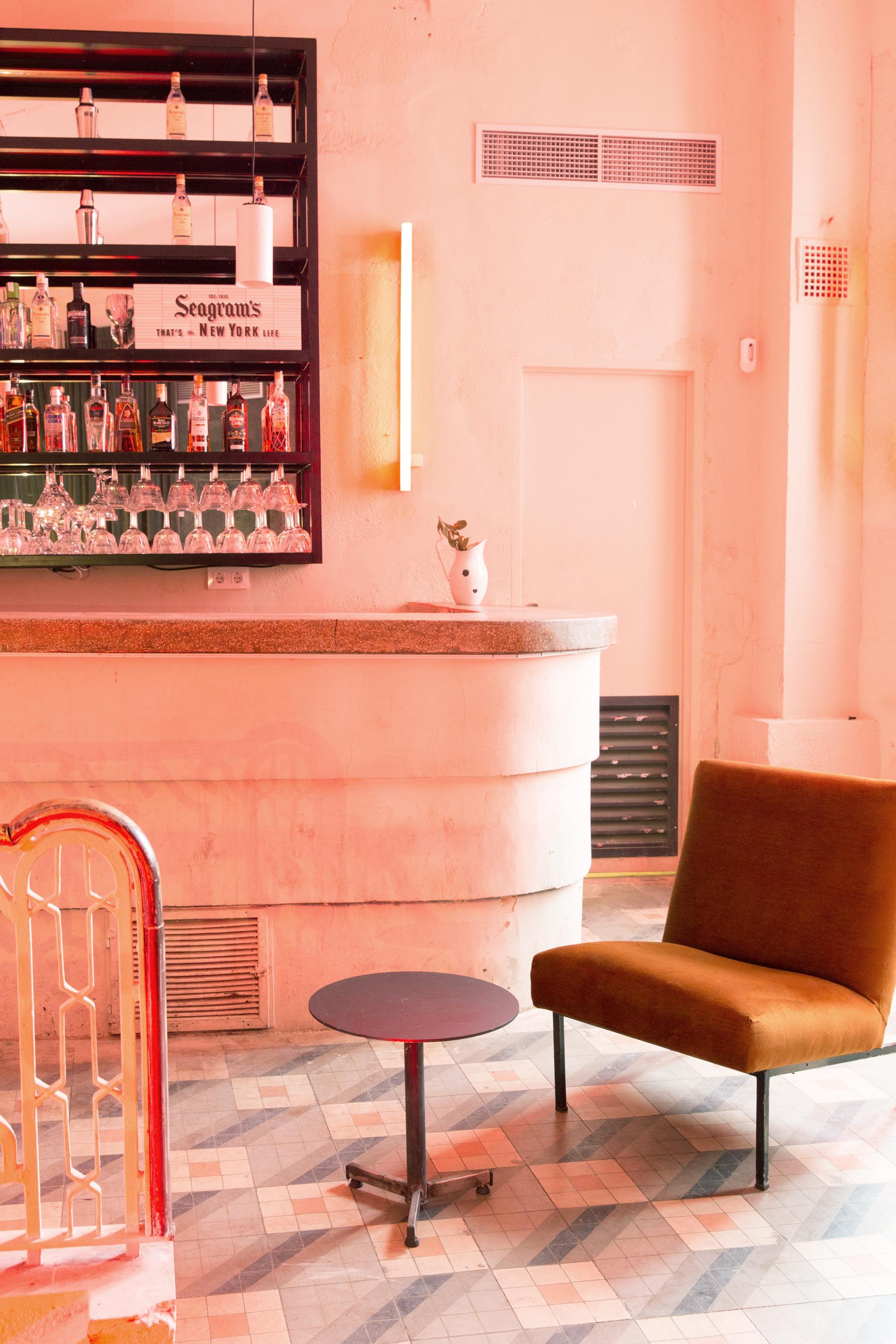 Stylish bar setting featuring vintage decor, artistic lighting, and a cozy seating area, reflecting Americana-inspired interior design.