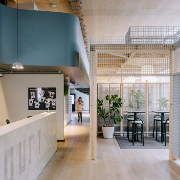 Modern interior design featuring functional workspaces and greenery, inspired by Mile End's historic streets, at iQ East Court.